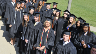 graduates line up for Commencement